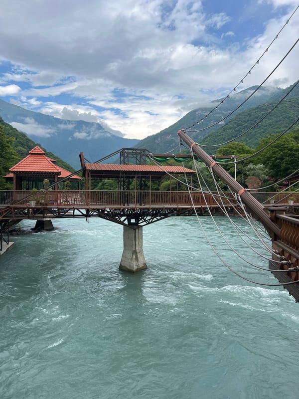 Elaborate riverside restaurant complex on a turquoise mountain river in Abkhazia