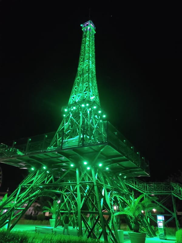 Illuminated Eiffel Tower replica observed at night attraction