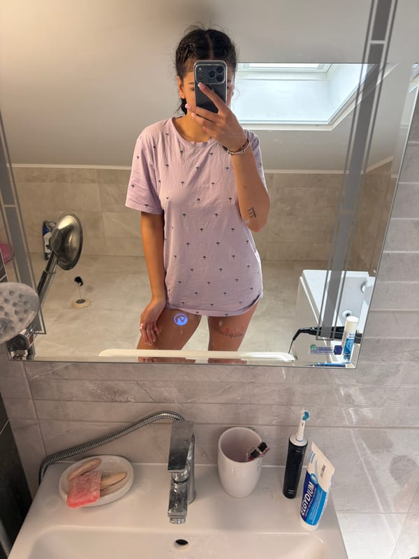 Woman takes bathroom mirror selfie in Gabrovo, Bulgaria