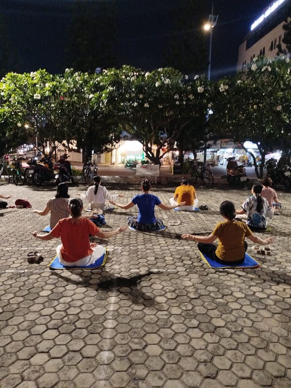 Group practices meditation on mats in Ho Chi Minh City