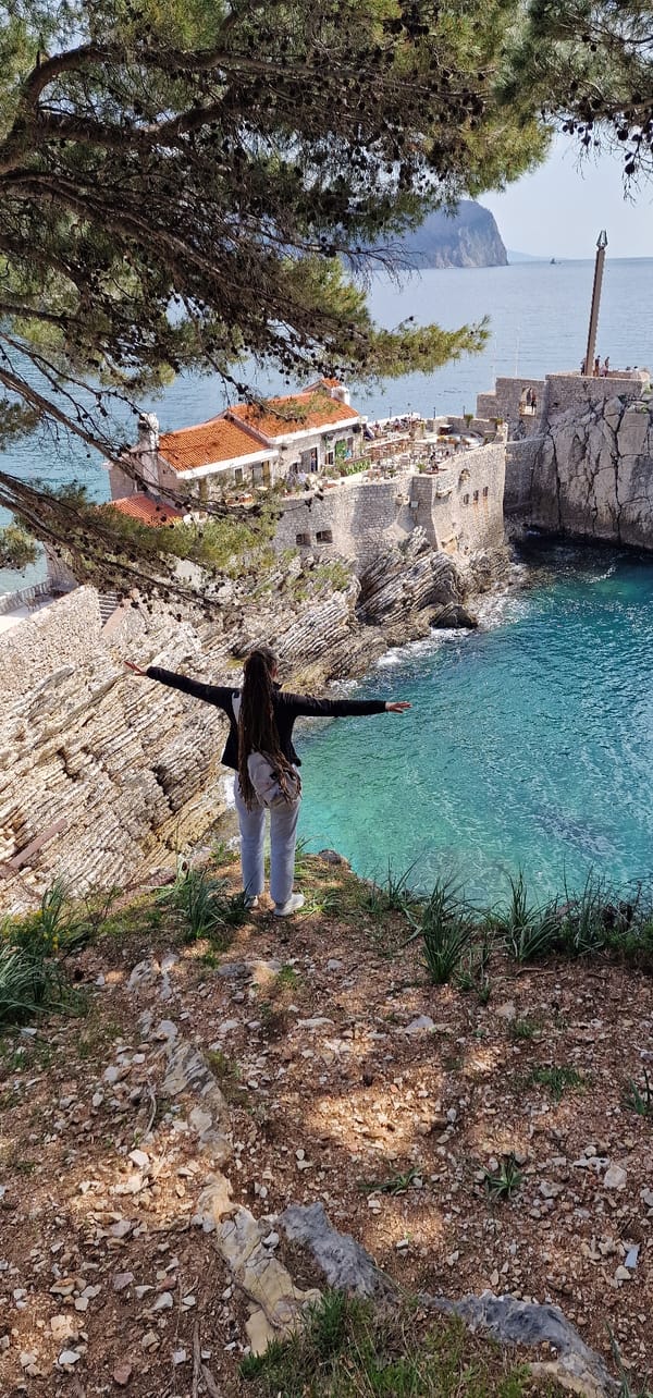 Visitors explore scenic coastal cliffs and fortress in Montenegro