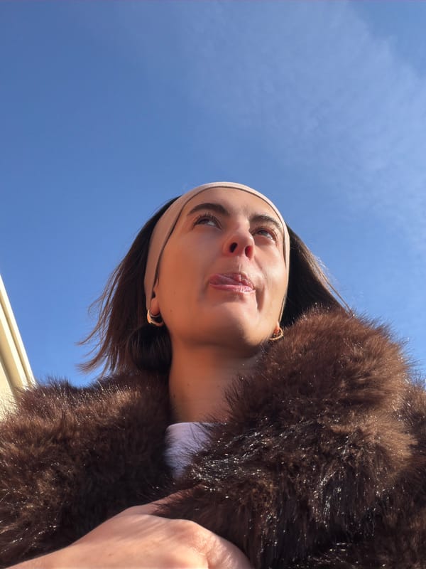 Woman in fur coat photographed against blue sky in Mascouche