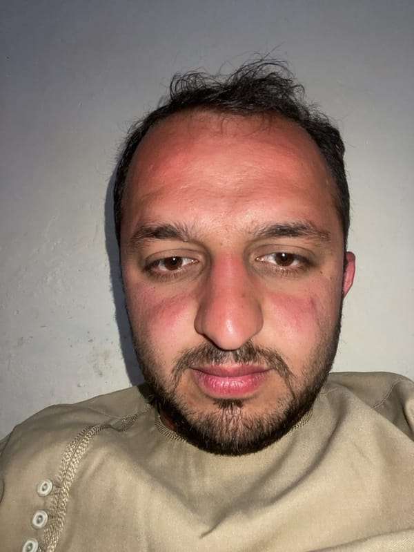 Welder repairs metal gate in Kandahar street scene