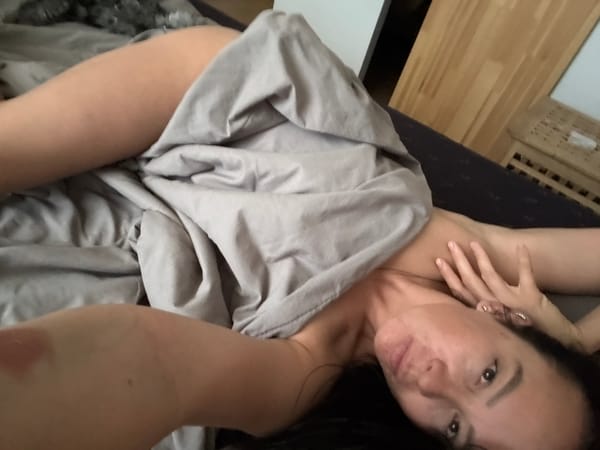 Woman rests in bedroom in Chaikovsky, Russia early morning