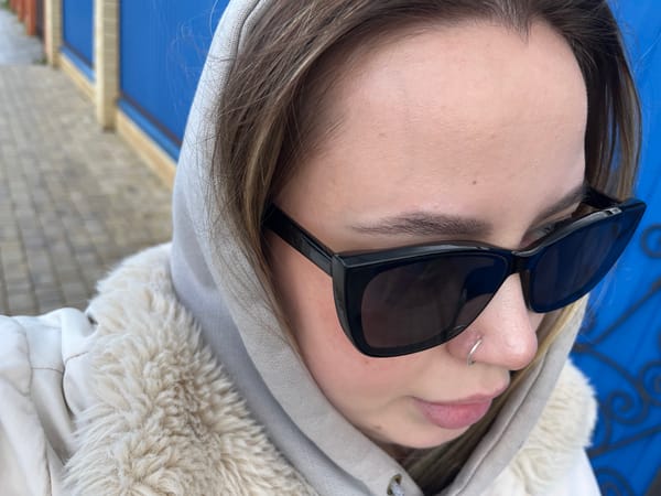 Person takes selfies near flowering trees in Novopokrovskaya