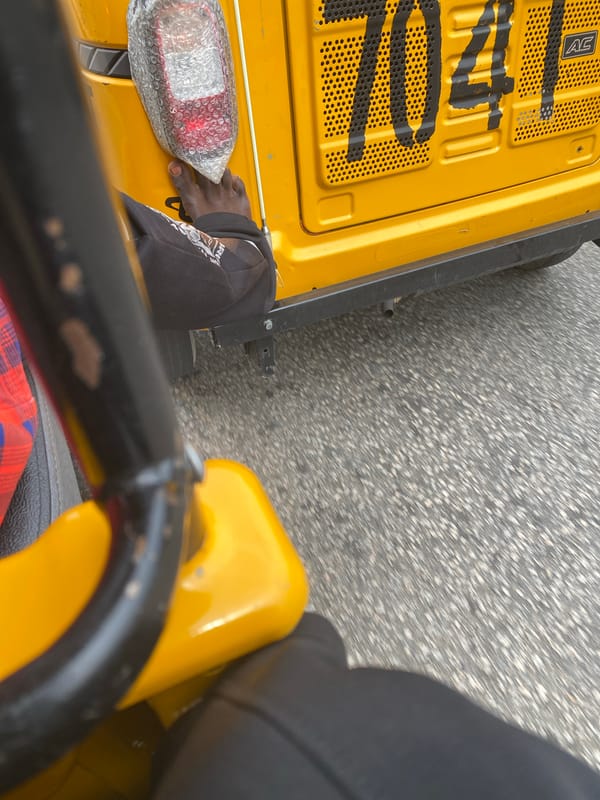 Riding through Jalingo streets in a yellow Keke Napep