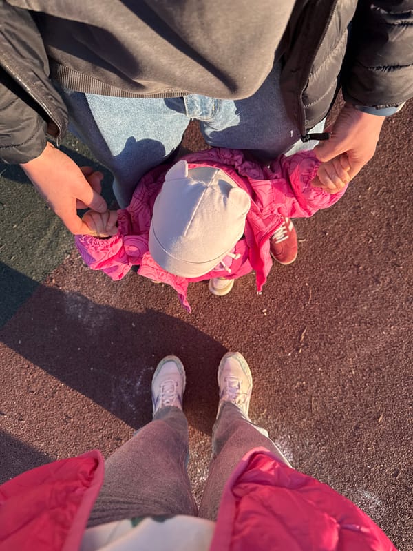 Family enjoys playground time with toddler in Moscow