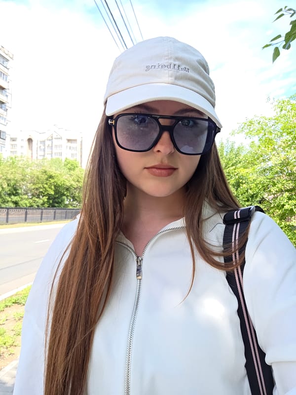 Woman takes selfies in white outfit during early morning