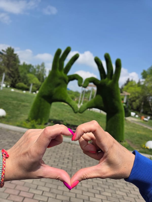 Woman makes heart gestures in Birobidzhan park early morning