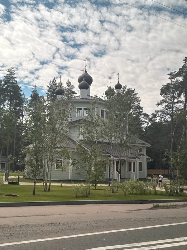 Green Orthodox church with onion domes in Solnechnoye, Russia