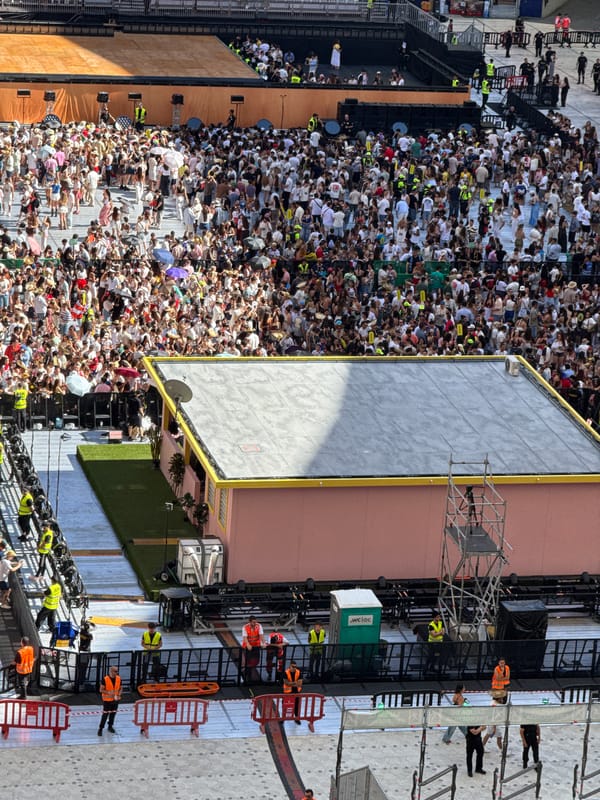 Thousands gather at outdoor stadium event under clear skies