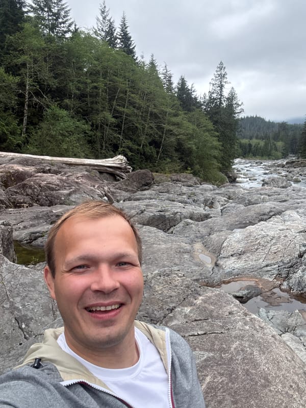 Three men photograph scenic river gorge in Long Beach