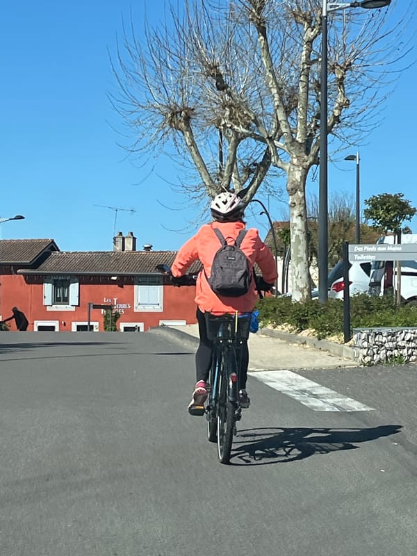 Cyclist spotted riding through Chambœuf, France wearing orange jacket