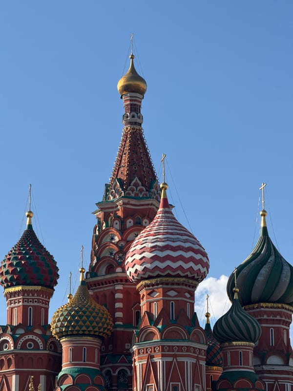 Tourist photographs St. Basil's Cathedral domes in Moscow