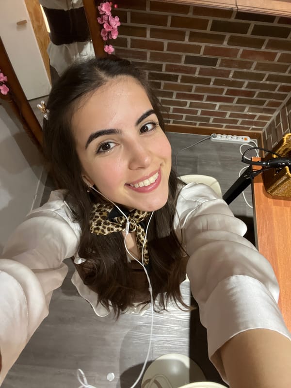 Woman takes smiling selfie in Seoul wearing leopard scarf