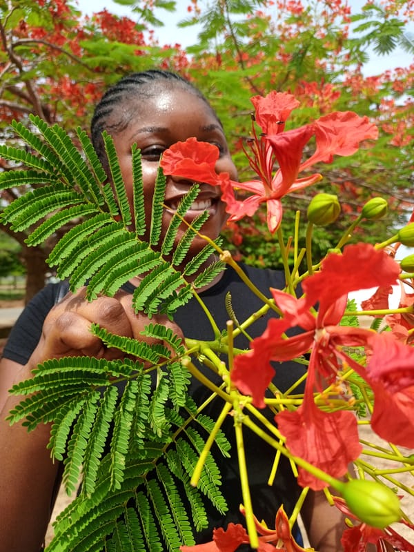 NSUK student photographed with flowers in Keffi outdoor setting