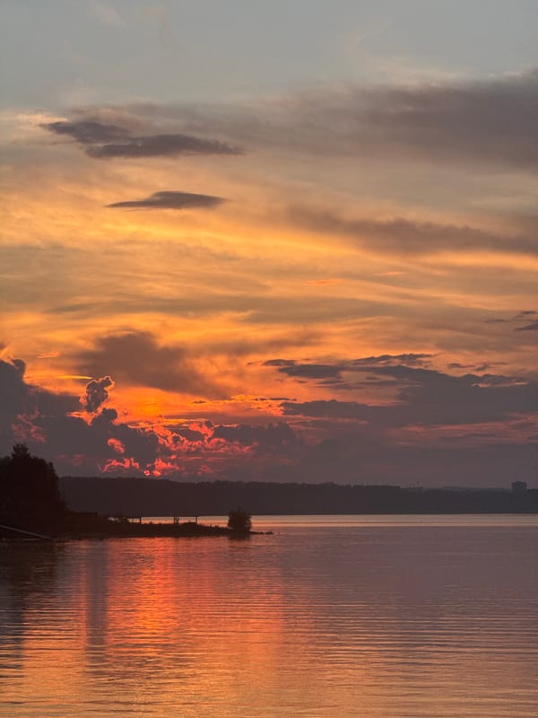 Lakeside campfire gathering during sunset on Kama River