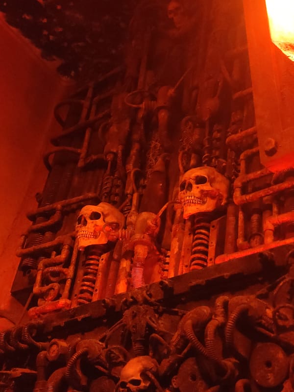 Industrial horror display with metal skulls and illuminated signage
