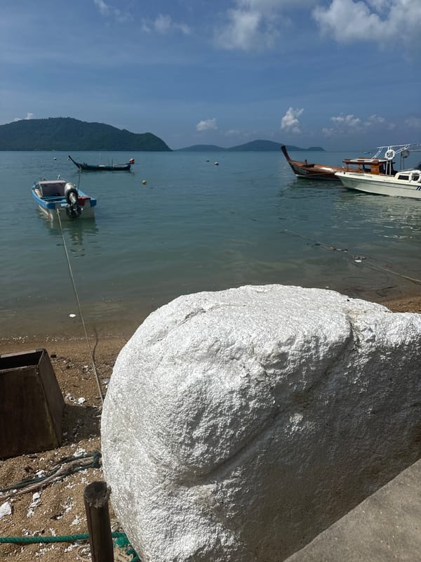 Quiet morning on Rawai Beach, boats moored, fishing in the shallows