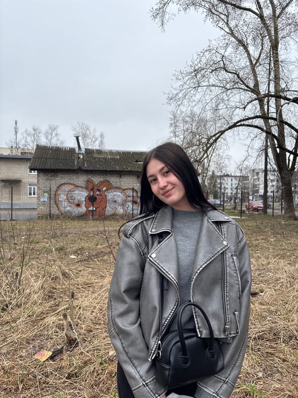 Woman photographed in casual portraits near graffitied building in Chaikovsky