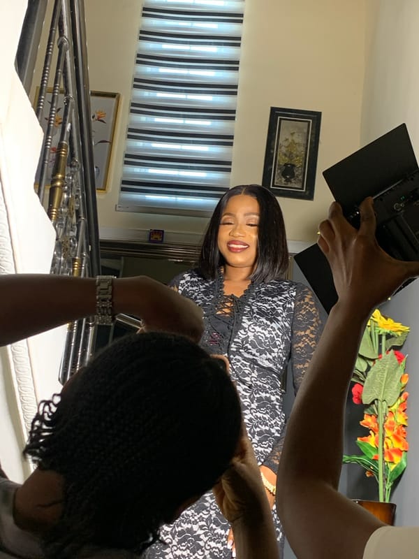 Woman poses for smartphone photoshoot on staircase in Jos
