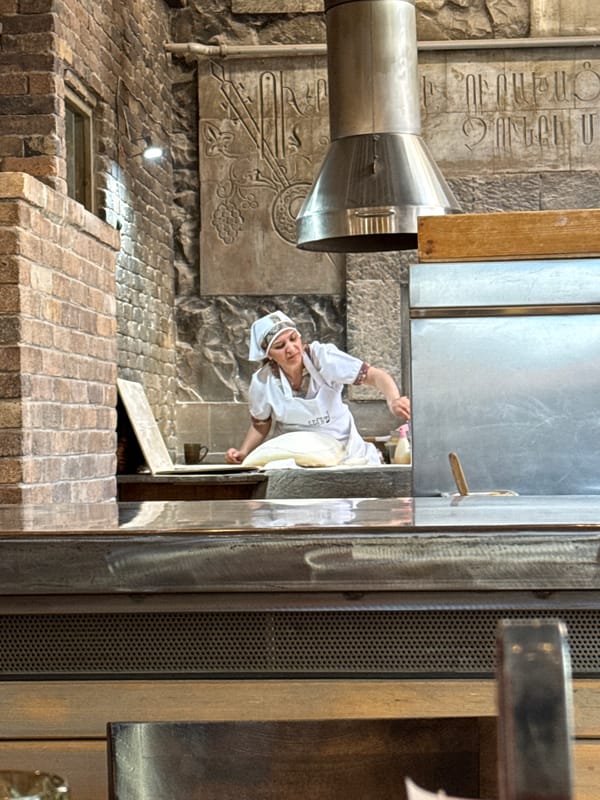 Traditional food preparation and dining captured at Yerevan restaurant