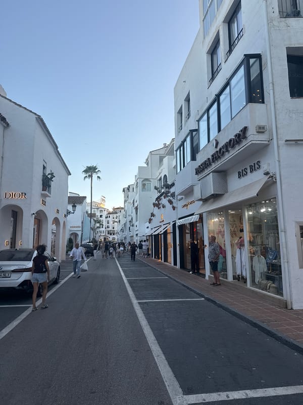 Luxury cars and designer boutiques fill Marbella's golden-hour streets