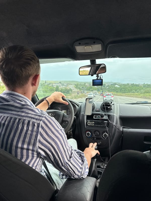 Backseat view of a driver on the road in Nadezhda