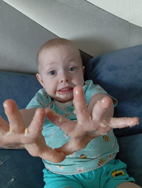 Toddler rests on blue couch in Yurgamysh, Russia