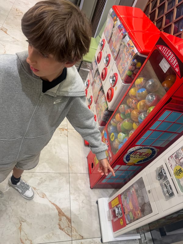 Family enjoys evening at toy vending machine in Portugal