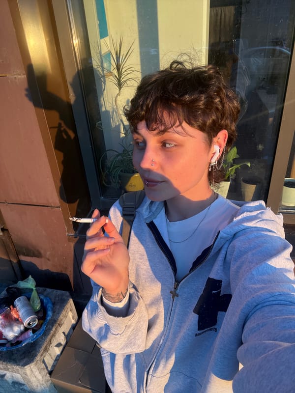 Person takes smoking selfie during golden hour in Saint Petersburg