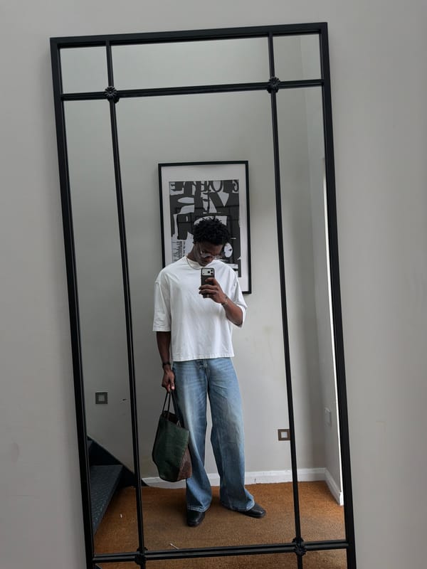Man takes mirror selfie in London interior space
