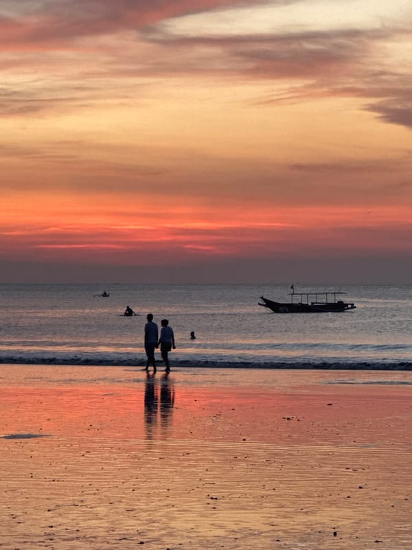 Sunset beach life unfolds in Kuta Selatan with horses and tourists
