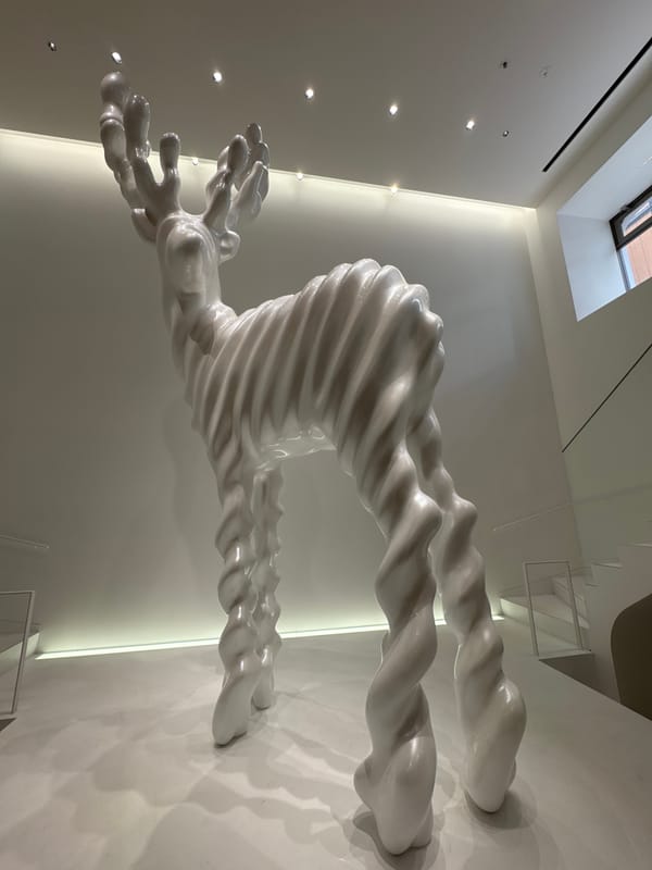 White Abstract Sculpture With Twisted Humanoid Form Observed