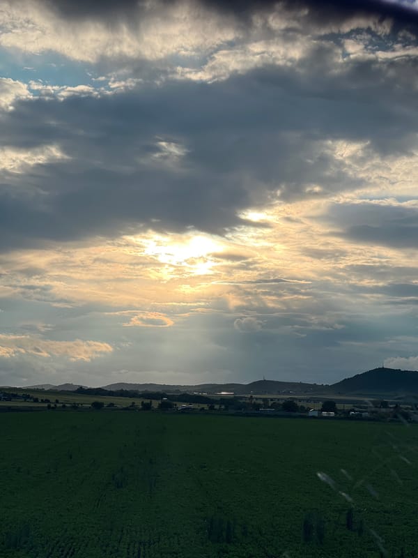 Bright sunlight breaks through clouds over Bulgarian countryside