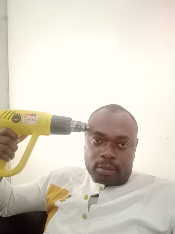 Man uses heat gun indoors in Gwarinpa, Nigeria