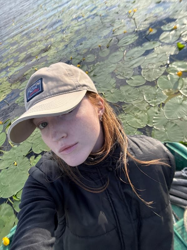 Outdoor portrait and lily pads on dark water, Saint Petersburg