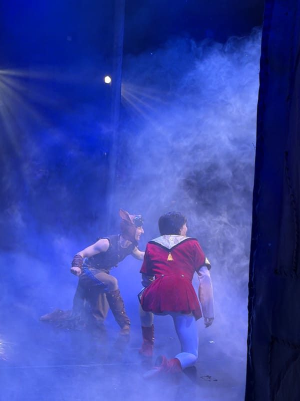 Ballet performance with fog, blue lights, and crescent moon backdrop
