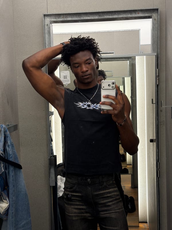 Young man tries on clothes in London fitting room