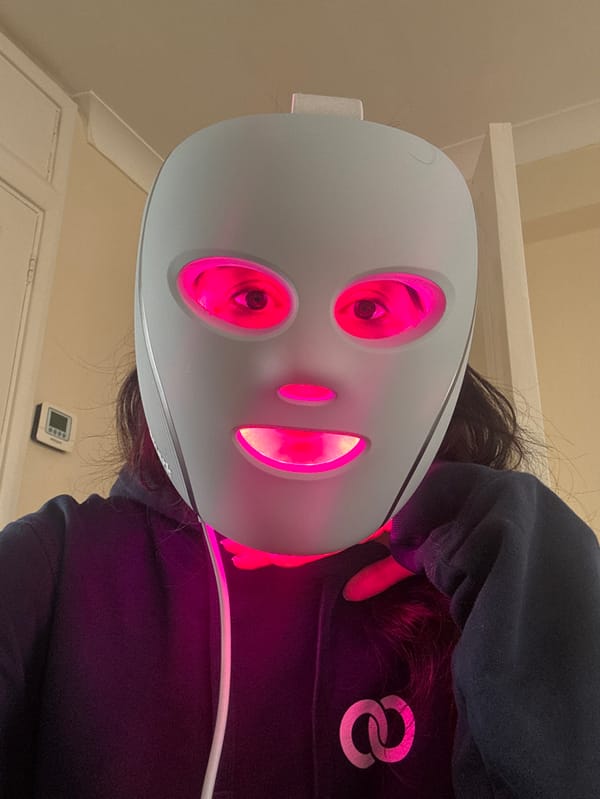 Person uses LED light therapy mask in London indoor setting
