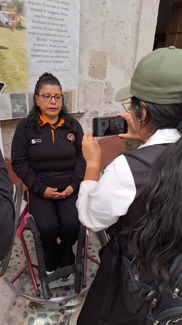 Women gather in stone courtyard for apparent interview session