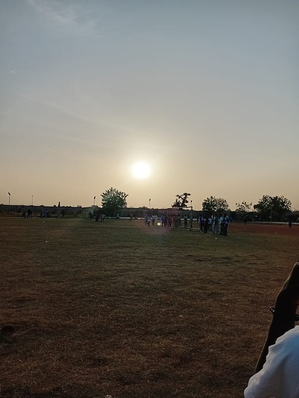 Group gathers in sunlit field in Dabawa, Nigeria