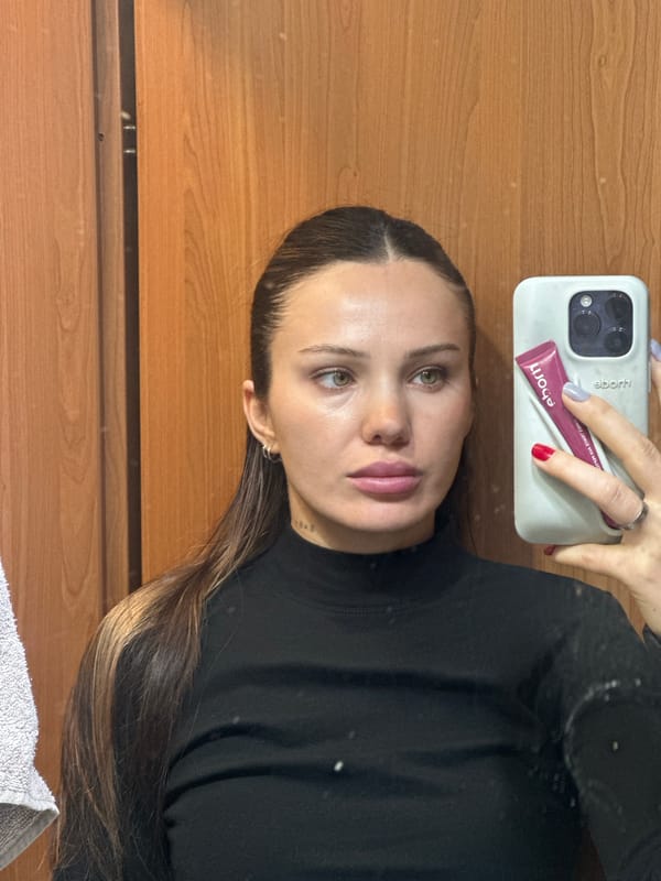Woman displays iPhone and maroon tube in Belgrade