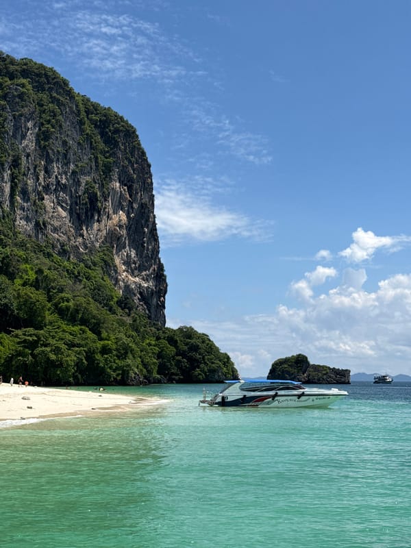 Limestone cliff meets white sand beach in Ao Nang