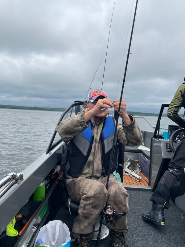 Fishing on a cloudy lake in Yablonovka, Russia
