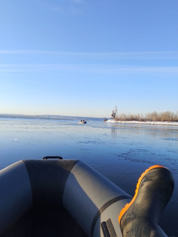 Boater navigates partially frozen waters near Chaikovsky industrial area