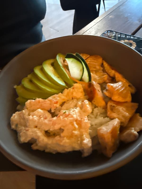 Woman documents dining experience at sushi restaurant in Mexico