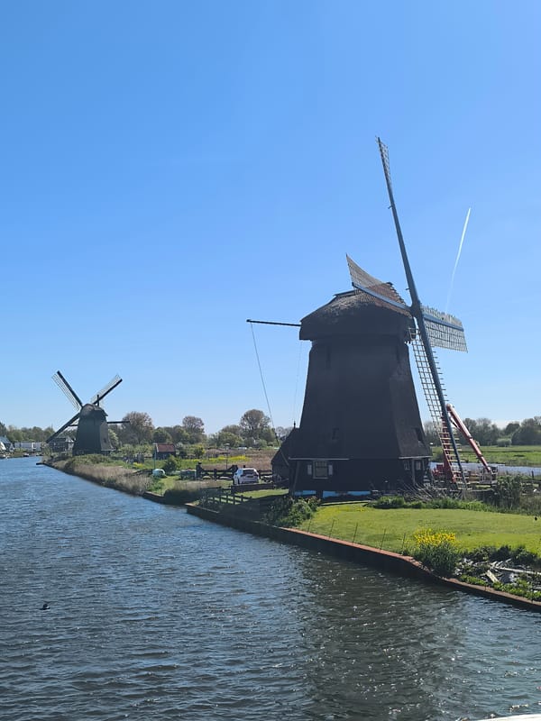 Dutch canal scene with windmills, boats documented in Alkmaar