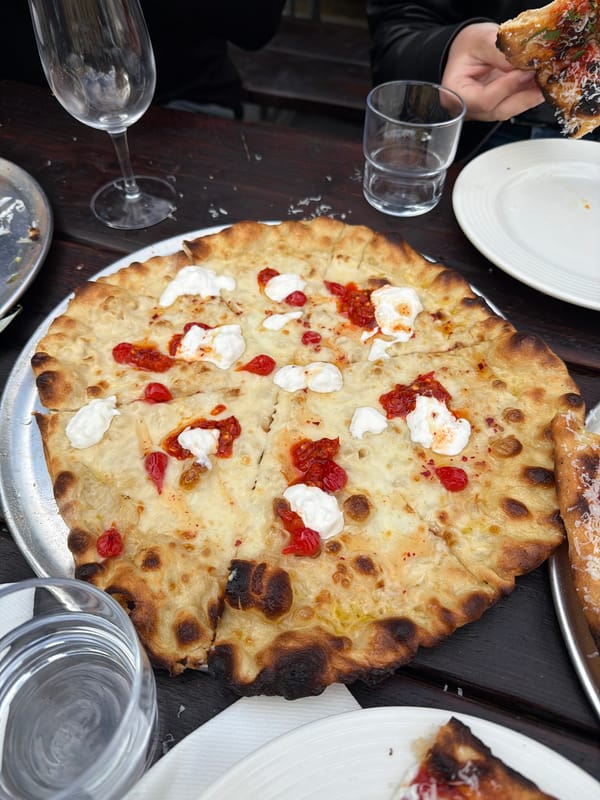 Diners share pizza at London's Weezie's restaurant during afternoon meal
