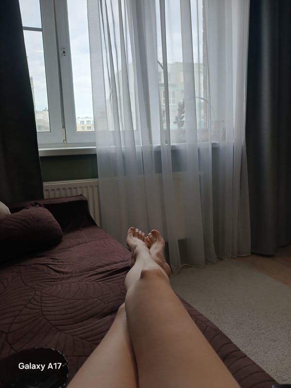 Person rests on sofa in Yekaterinburg apartment